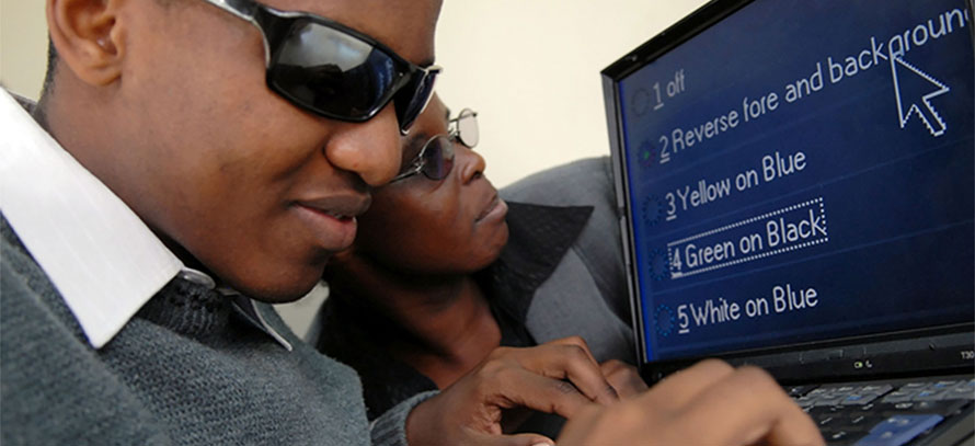 Visually impaired man using high contrast settings on a computer