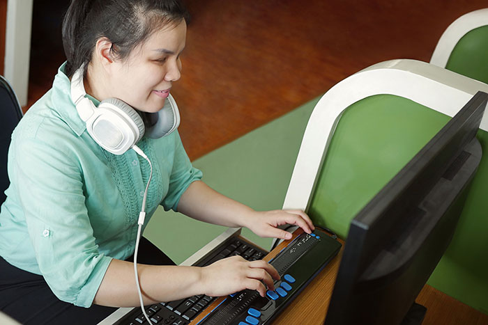 Blind woman using a braille keyboard